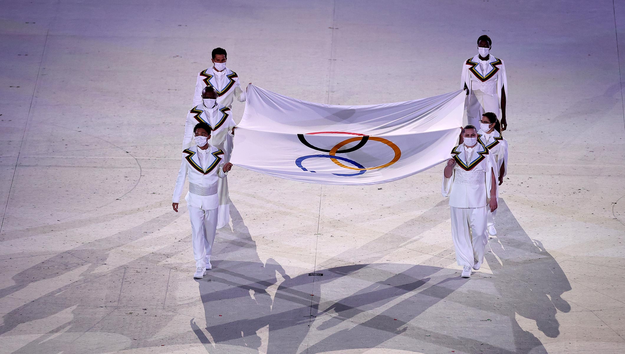 The flag bearers of the Olympic flag