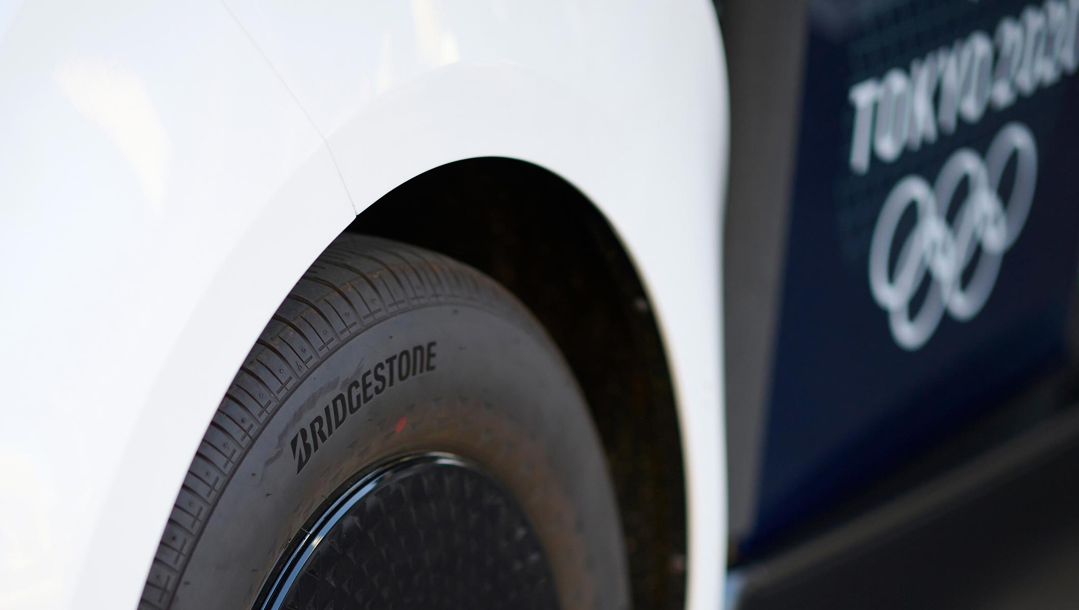 Bridgestone the official tyre of Tokyo 2020 on a vehicle in the Olympic Village