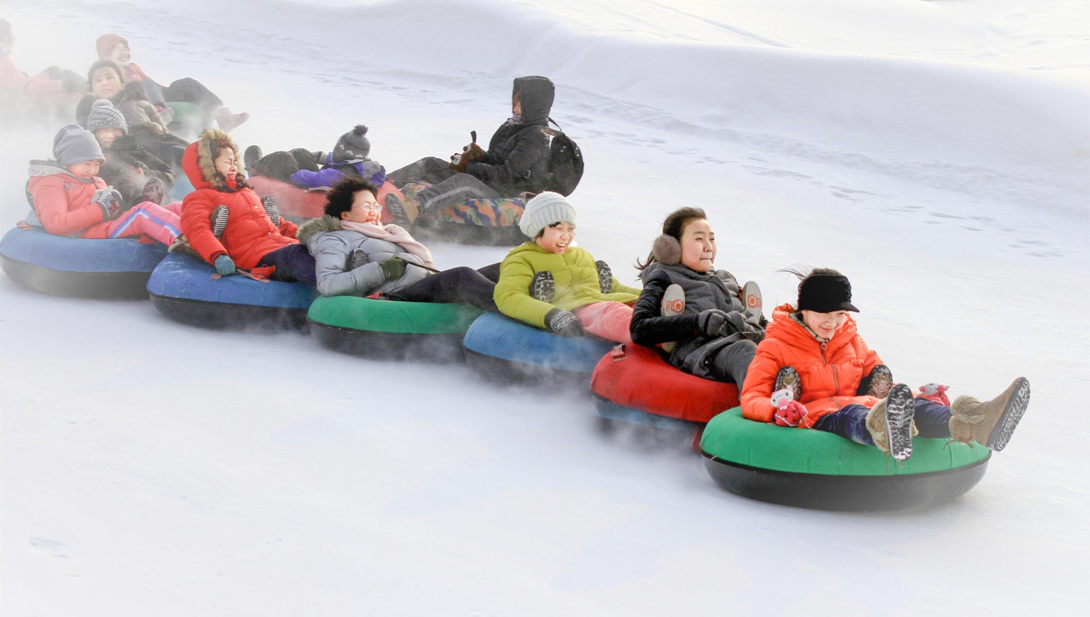 Chinese tourists participating in snow entertainment activities