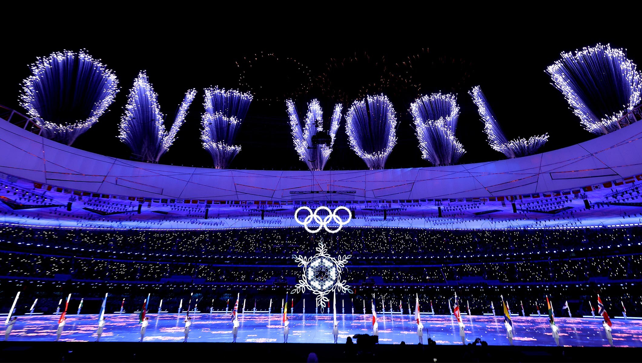 A firework display is seen inside the stadium alongside the Olympic rings during the Beijing 2022 Olympic Winter Games Closing Ceremony